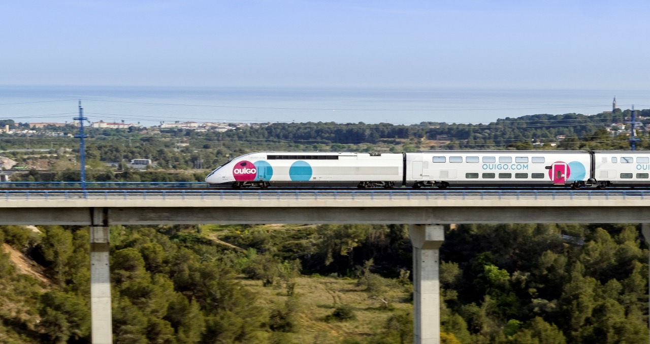 Ouigo train passing on a bridge.